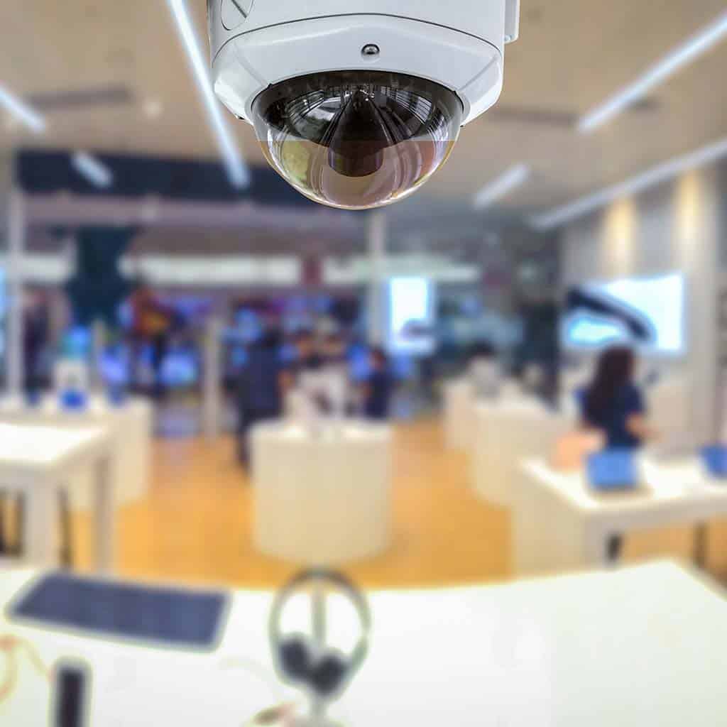 Novus Technology Integration - helpdesk - A white surveillance camera at the center of the working station.